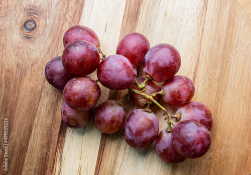 Fresh grapes on wooden background. Selective focus with shallow depth of field.