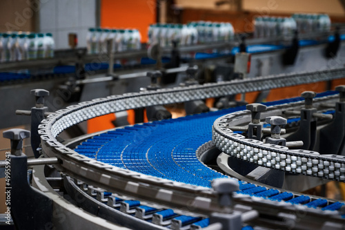 Empty plate conveyor belt and bottles at production line photo