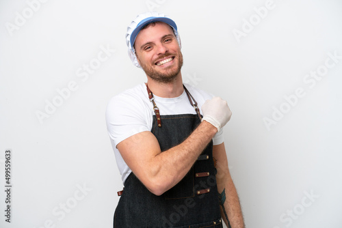 Quadro su tela Fishmonger man wearing an apron isolated on white background celebrating a victo