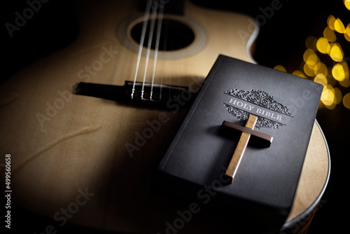 Holy Bible with guitar and religious crucifix cross, gospel music concept photo