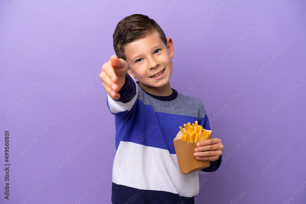 Little boy holding fried chips isolated on purple background shaking hands for closing a good deal Little boy holding fried chips isolated on purple background shaking hands for closing a good deal