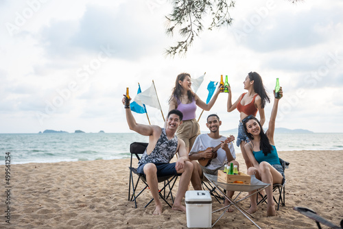 Group of Asian young man and woman having party on the beach together. 