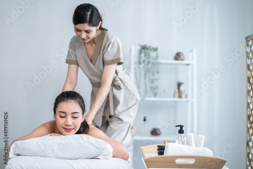 Asian young woman feeling happy and relax during back massage with oil