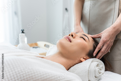 Asian young woman feel happy and relax during facial and head massage.