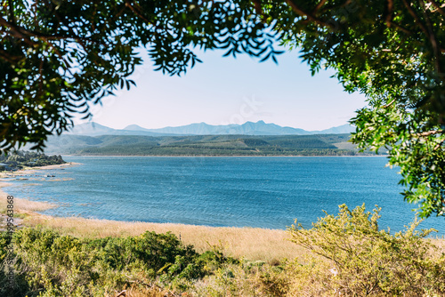 Blick auf einen türkisfarbenen See in Südafrika an der Garden Route mit Bergen im Hintergrund © schwede-photodesign