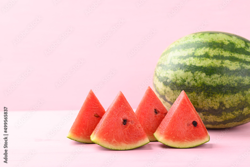 Sliced watermelon on pink color background, Tropical fruit in summer season Sliced watermelon on pink color background, Tropical fruit in summer season