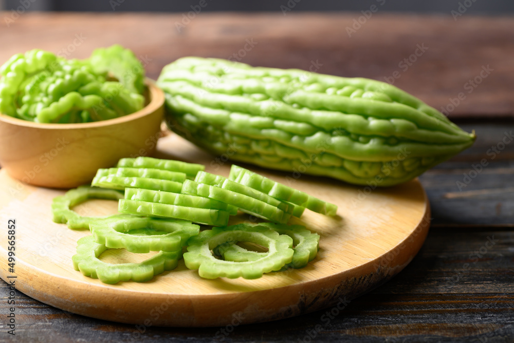 Sliced bitter melon or bitter gourd on wooden board prepare for cooking Sliced bitter melon or bitter gourd on wooden board prepare for cooking