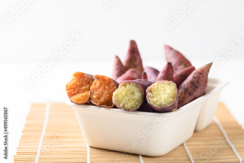 Orange and yellow sweet potatoes ready to eating in biodegradable bowl