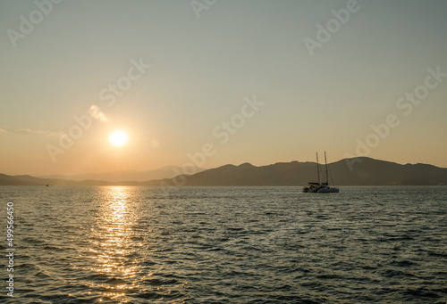 Evia island, Greece - July 01. 2020: Sunset on the island of Evia, Greece. © caocao191