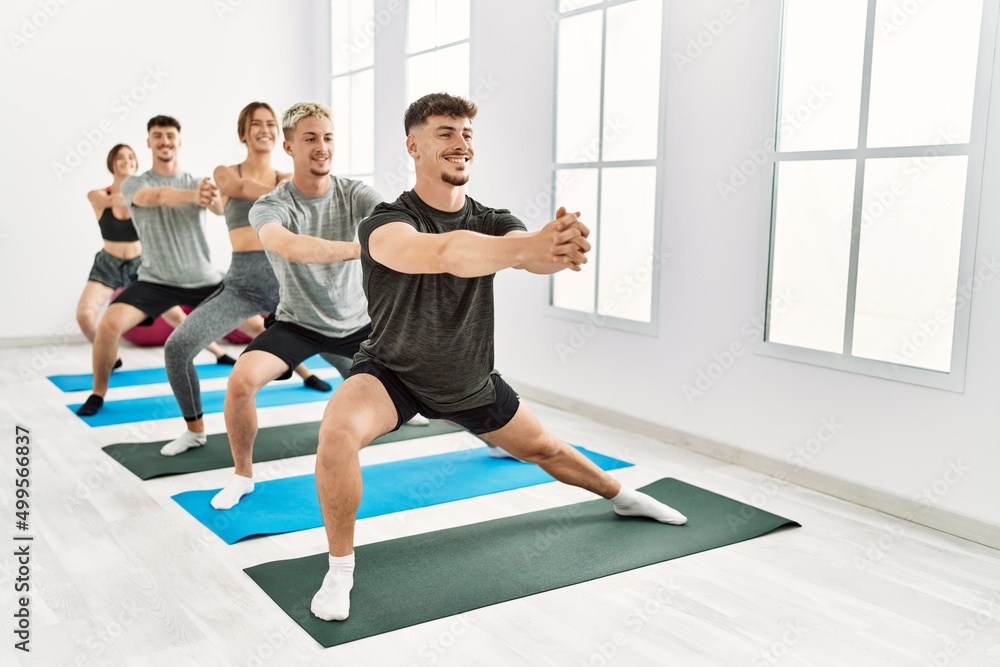 Fototapeta premium Group of young hispanic people smiling happy training at sport center.
