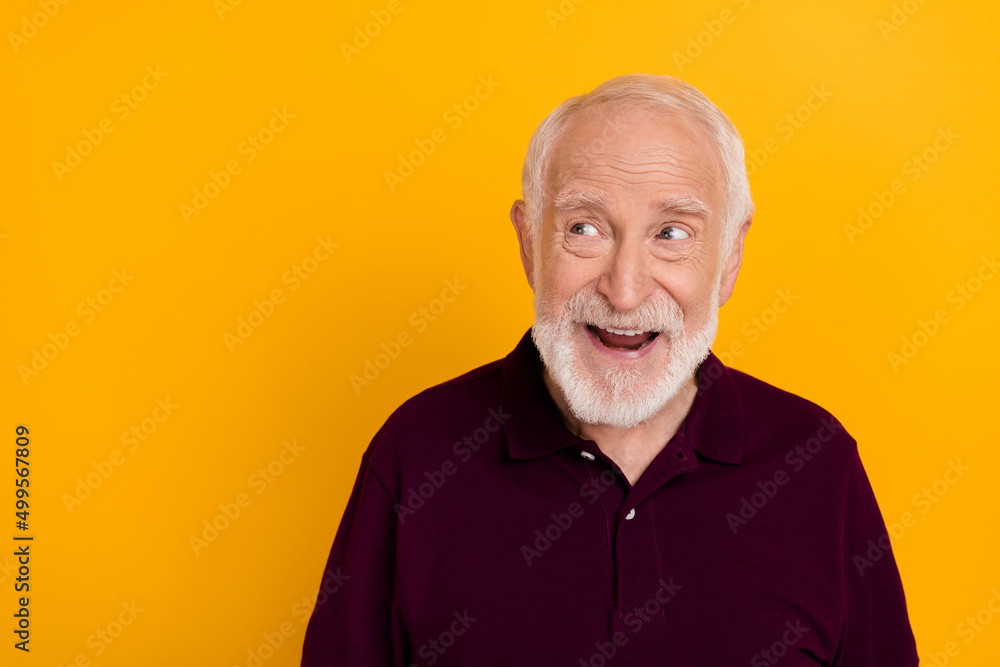 Photo of senior excited man look empty space wonder curious think isolated over yellow color background Photo of senior excited man look empty space wonder curious think isolated over yellow color background