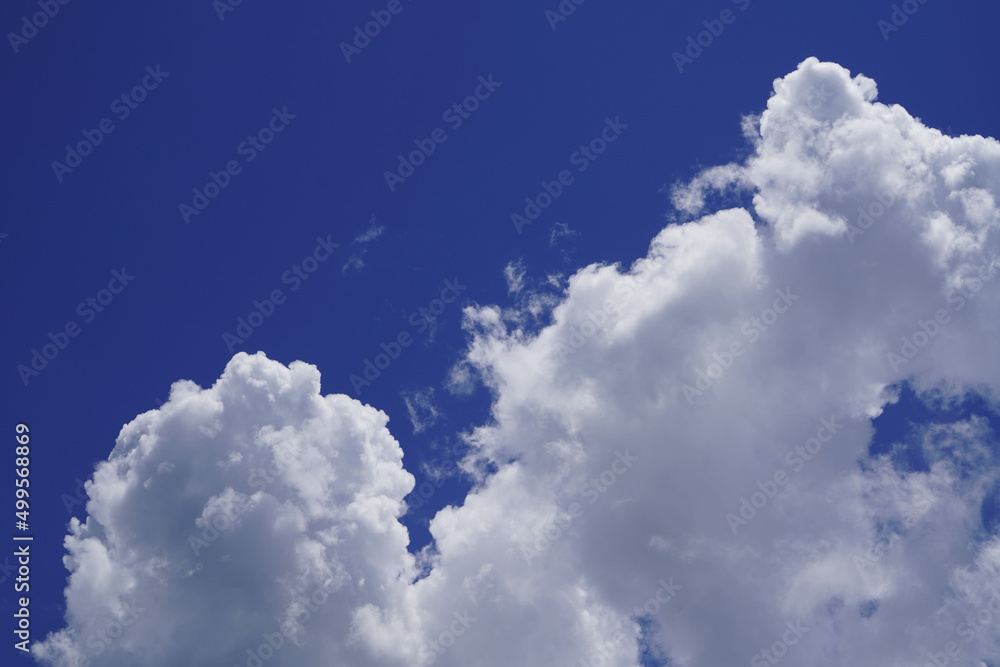 Blue sky with white clouds. Sky and clouds during the daytime in the summer. white fluffy clouds in the blue sky. Blue sky with white clouds. Sky and clouds during the daytime in the summer. white fluffy clouds in the blue sky.