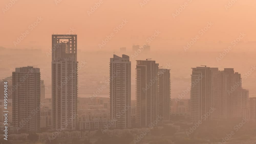 Greens and al barsha heights district area night to day timelapse from Dubai marina. Greens and al barsha heights district area night to day timelapse from Dubai marina.