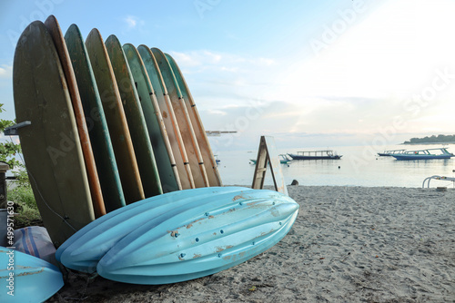 Rows of surfer boards parking in sandy beach 