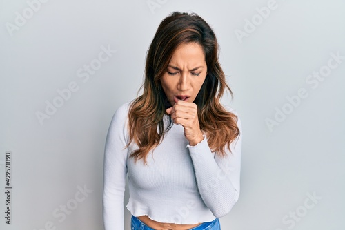 Young latin woman wearing casual clothes feeling unwell and coughing as symptom for cold or bronchitis. health care concept.