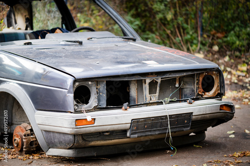 The rusty remains of the car  was in an accident  an abandoned car. Covered with rust  in poor condition