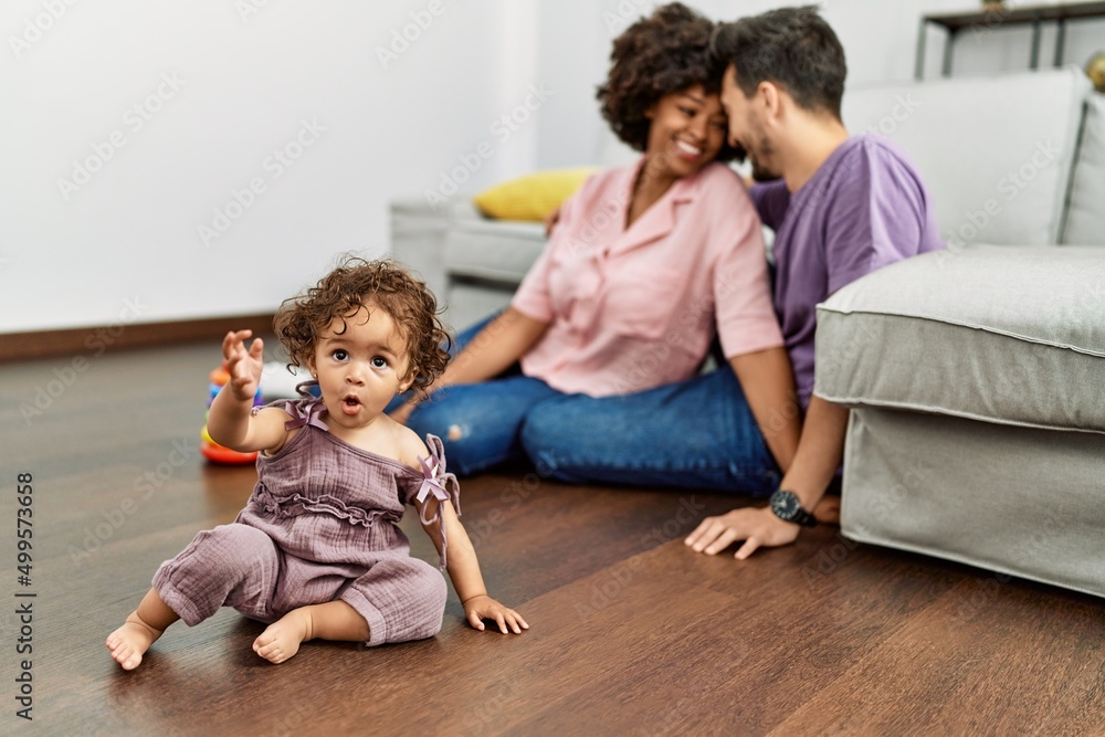 Couple and daughter smiling confident playing with toys sitting on the floor at home Couple and daughter smiling confident playing with toys sitting on the floor at home