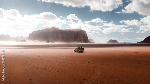 Tourist jeep tour in Wadi Rum desert in Jordan, natural landscape surrounded by dry and rocky mountains, beautiful attraction in the middle east for adventure tourism photo