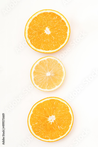 Flat lay of the three orange slices lying isolated on white background