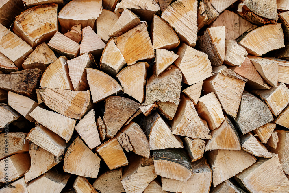 Natural wooden background. Chopped firewood. Firewood is stacked and prepared for winter. Natural wooden background. Chopped firewood. Firewood is stacked and prepared for winter.