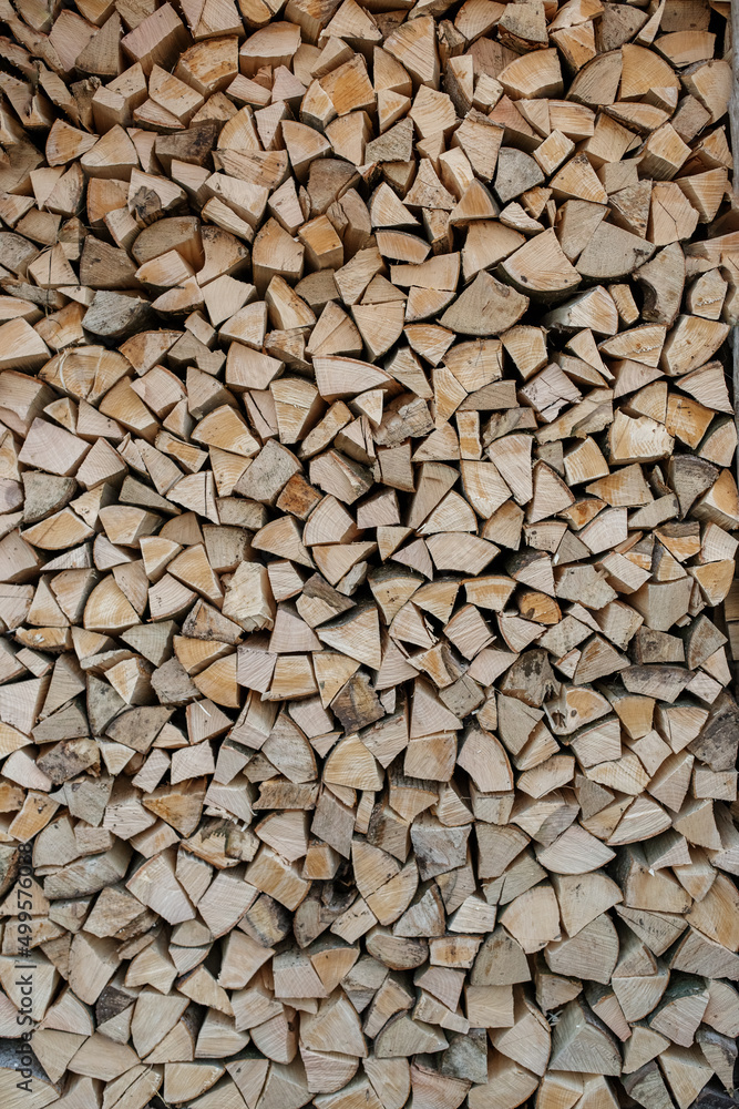 Natural wooden background. Chopped firewood. Firewood is stacked and prepared for winter.