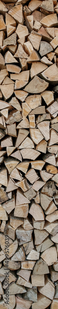 Fototapeta premium Natural wooden background. Chopped firewood. Firewood is stacked and prepared for winter.