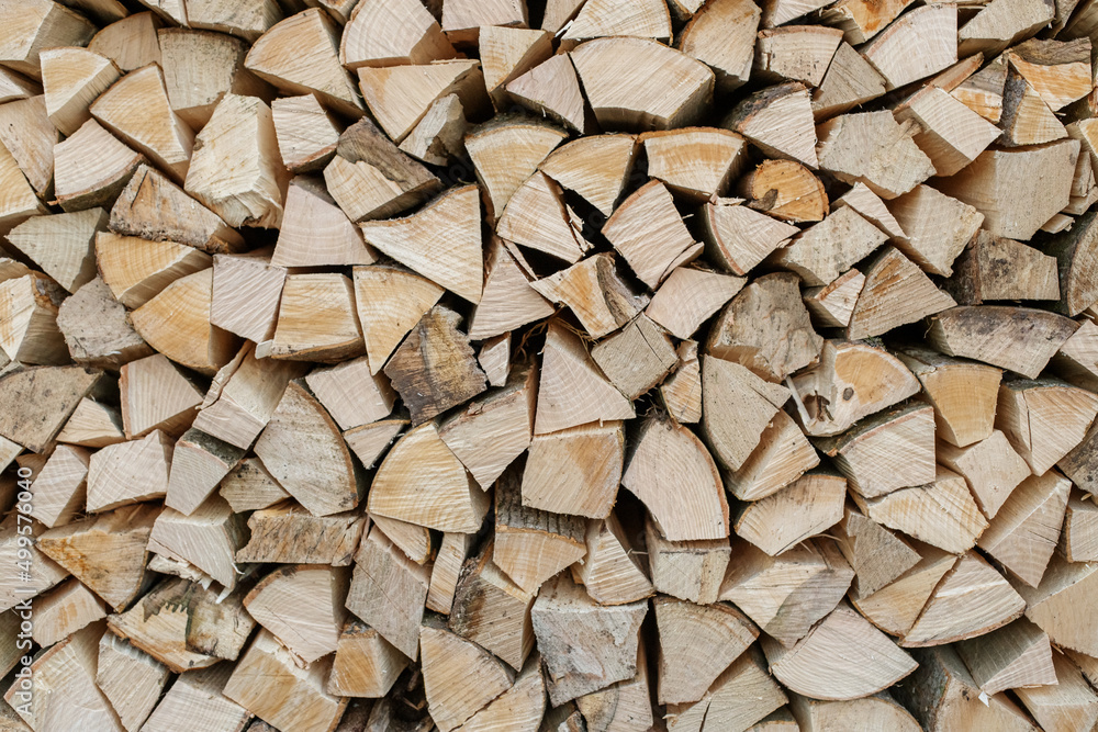 Natural wooden background. Chopped firewood. Firewood is stacked and prepared for winter. Natural wooden background. Chopped firewood. Firewood is stacked and prepared for winter.
