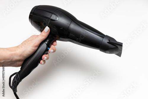 woman holding black hair dryer traces of use