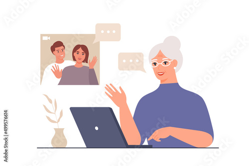 Happy grandma calls her daughter or son by videoconference. Elderly woman at table with laptop. Concept of video call conference, online meeting, communication at a distance.