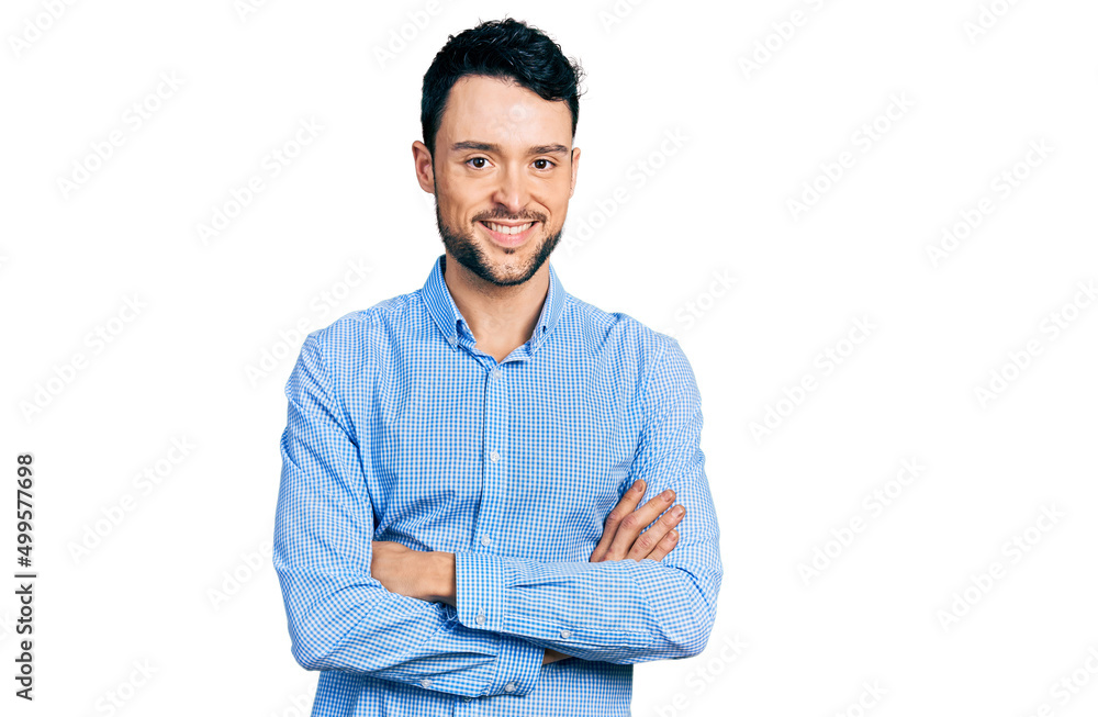 Hispanic man with beard with arms crossed gesture smiling with a happy and cool smile on face. showing teeth.