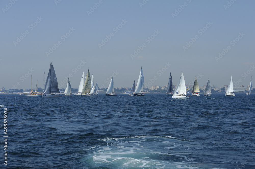 Naklejka premium Seascape with sailboat the background of the blue sky.Beautiful sailboat sailing sail blue Mediterranean sea ocean horizon.