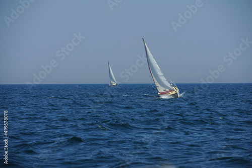Seascape with sailboat the background of the blue sky.Beautiful sailboat sailing sail blue Mediterranean sea ocean horizon.