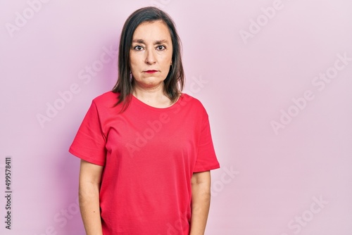 Middle age hispanic woman wearing casual clothes skeptic and nervous, frowning upset because of problem. negative person.