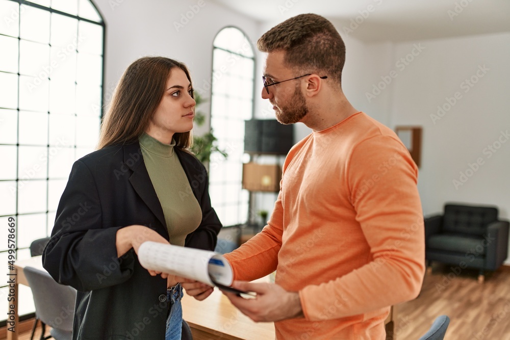 Obraz premium Two caucasian business executives working at the office.