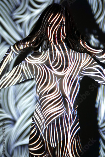 Obraz na plátně Projection from beamer or projector on woman looks like body painting with zebra