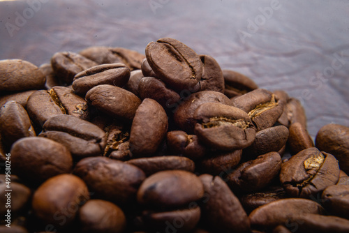 Coffee beans. Coffee beans are spread out on the surface. Roasted coffee beans background, pattern, selective focus
