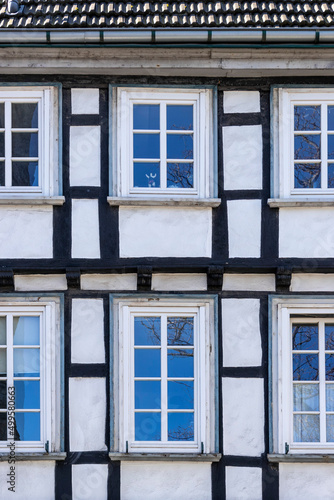 old half-timbered house facade with windows 
