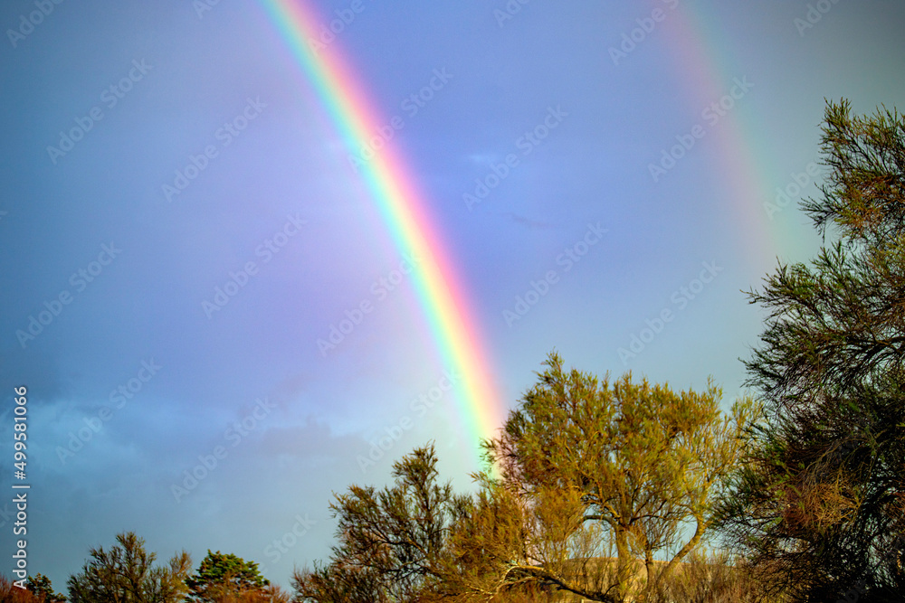 Rainbow  in atlantic ocean sunset