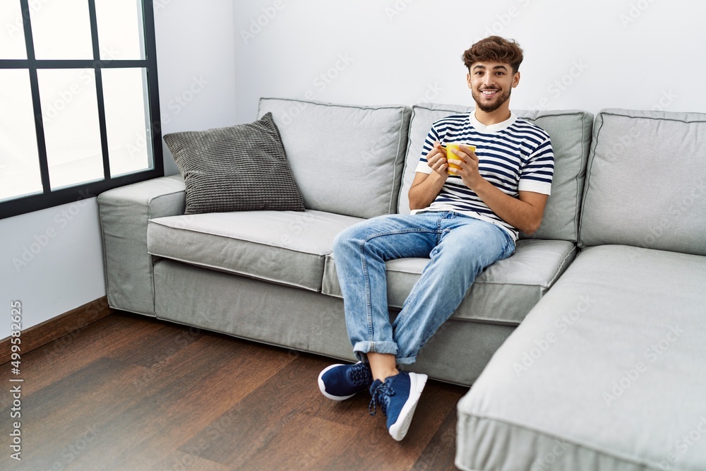 Young arab man smiling confident drinking coffee at home Young arab man smiling confident drinking coffee at home