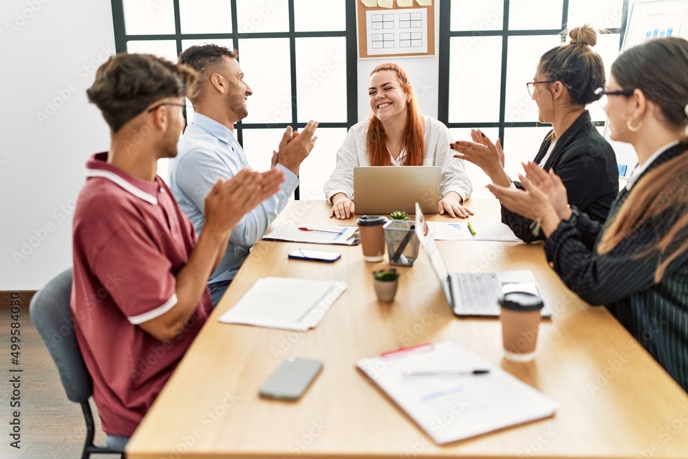 Group of business workers smiling and clapping to partner at the office. Group of business workers smiling and clapping to partner at the office.
