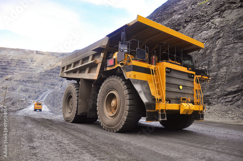 The work of a heavy quarry dump truck in the iron ore quarry.