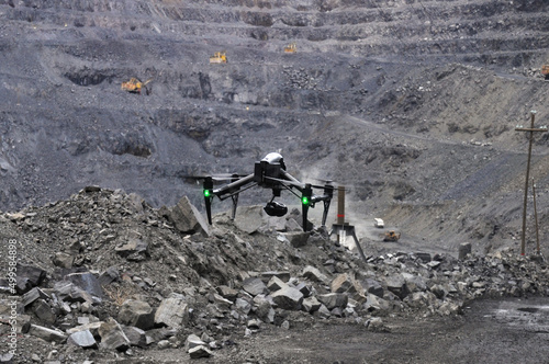 black drone filming in an iron ore quarry