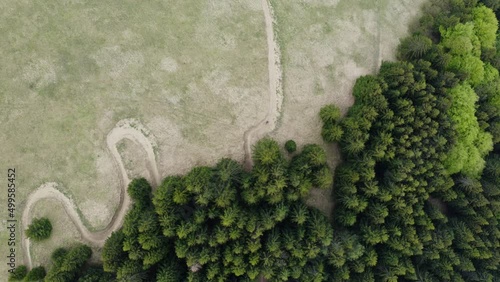 Malino Brdo Sports Resort, Ružomberok, Liptov, Slovakia - Aerial Drone View Of Curvy Bike Trail In Meadows Bounded By Lush Evergreen Trees In Summer. - Drone Vertical Shot photo