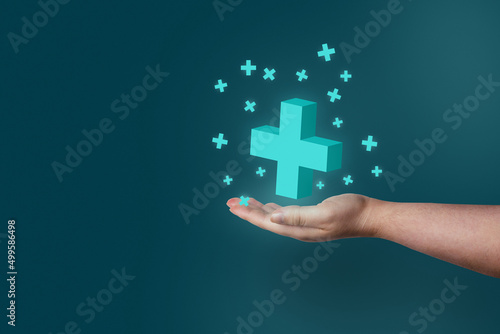 Woman hand showing medical cross shape and healthcare with copy space. Insurance service. Health care and medical services concept.