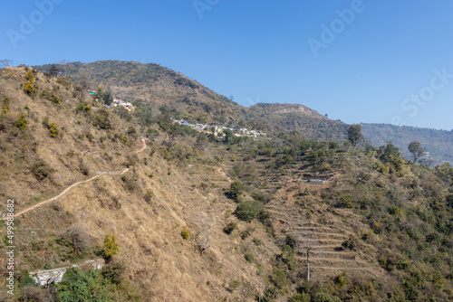 small village at mountain foothills with blue sky at morning