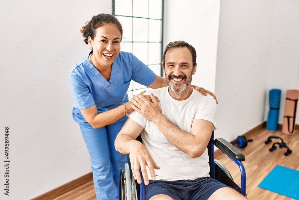 © Krakenimages.com - Middle age man and woman smiling confident having physiotherapy session at physiotherapy clinic © Krakenimages.com - Middle age man and woman smiling confident having physiotherapy session at physiotherapy clinic