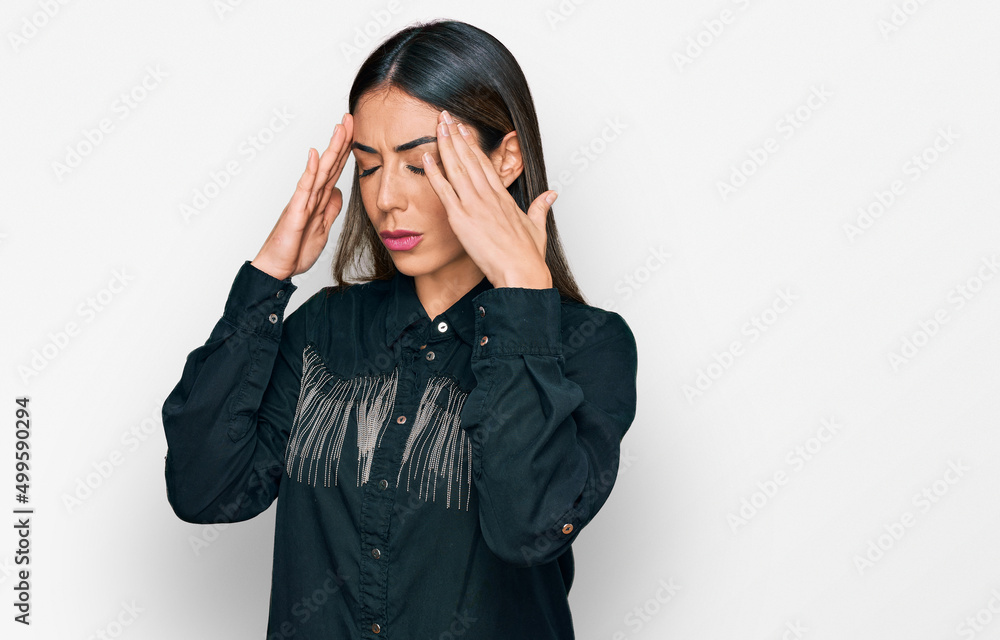 Young hispanic woman wearing casual clothes with hand on head for pain in head because stress. suffering migraine. Young hispanic woman wearing casual clothes with hand on head for pain in head because stress. suffering migraine.