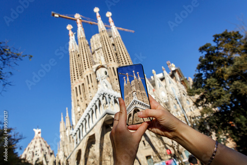 Using a mobile phone camera to take pictures of Sagrada Familia in Barcelona, Spain.