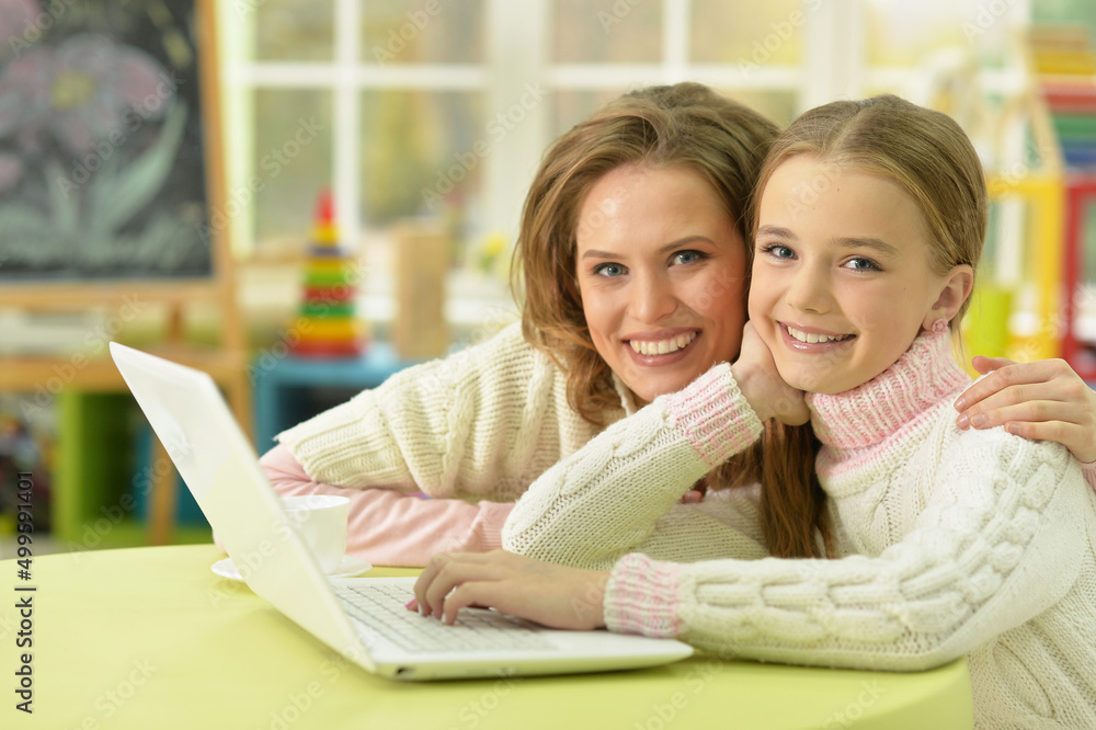 Portrait of mother and daughter using laptop Portrait of mother and daughter using laptop