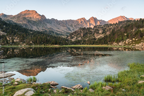 Sunrise at the mountain lake (Lake of Pessons, Andorra)